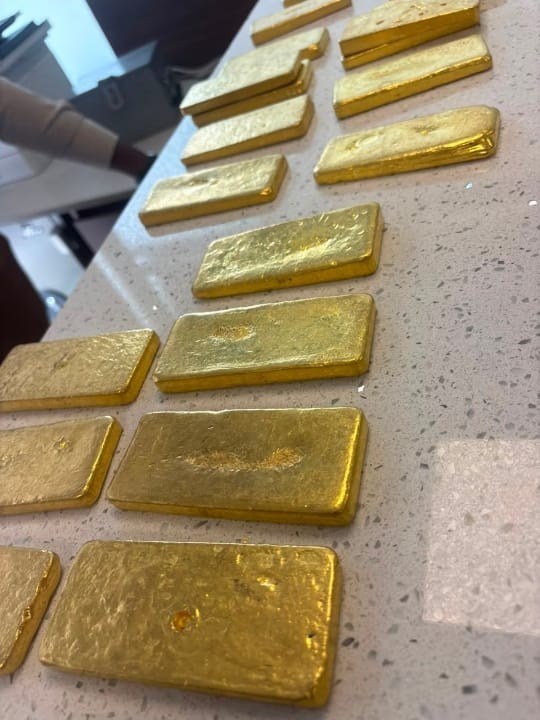 Gold bars laid out on a counter