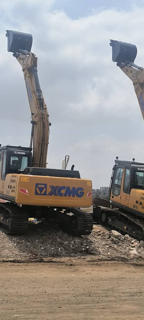 Two XCMG excavators with their booms raised