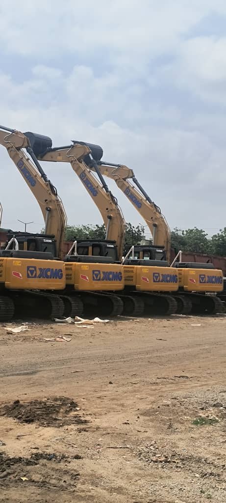 XCMG excavators lined up with their booms raised